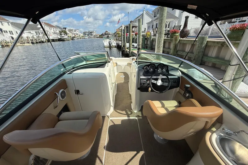 Slide: The Image of Interior view of 2014 Sea Ray 260 Sundeck boat docked by waterfront homes. - 17