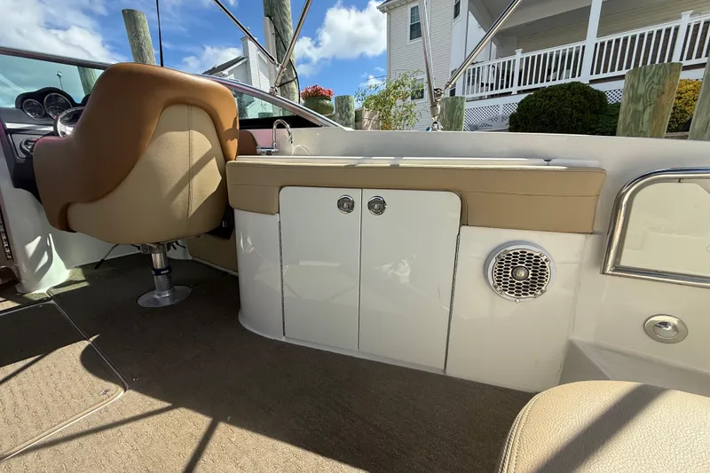 Slide: The Image of 2014 Sea Ray 260 Sundeck interior with seating, storage, and speaker. - 18