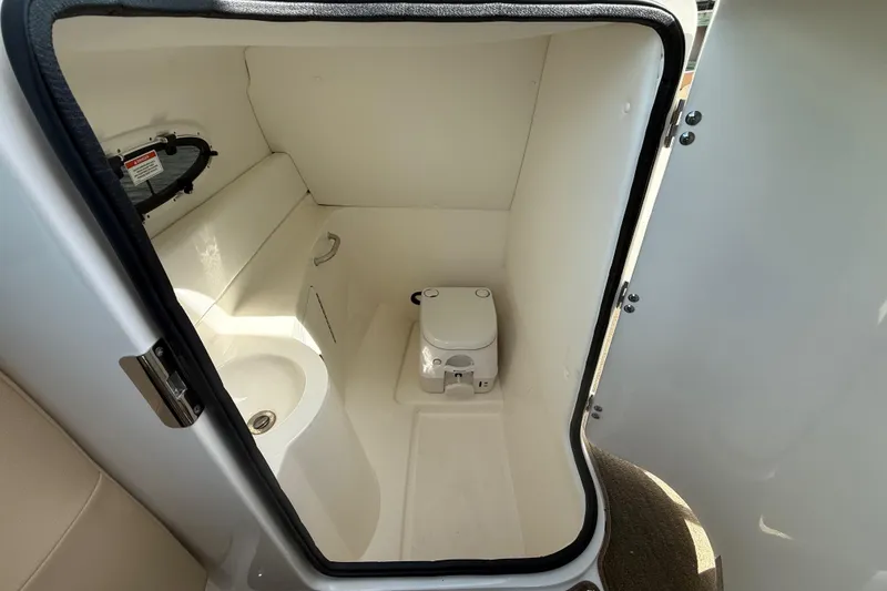 Slide: The Image of Interior of 2014 Sea Ray 260 Sundeck boat bathroom with toilet and sink. - 7