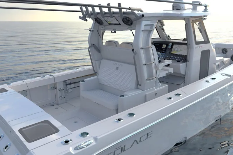 Slide: The Image of 2026 Solace 35 CS boat interior with modern helm, seating, and ocean backdrop. - 6