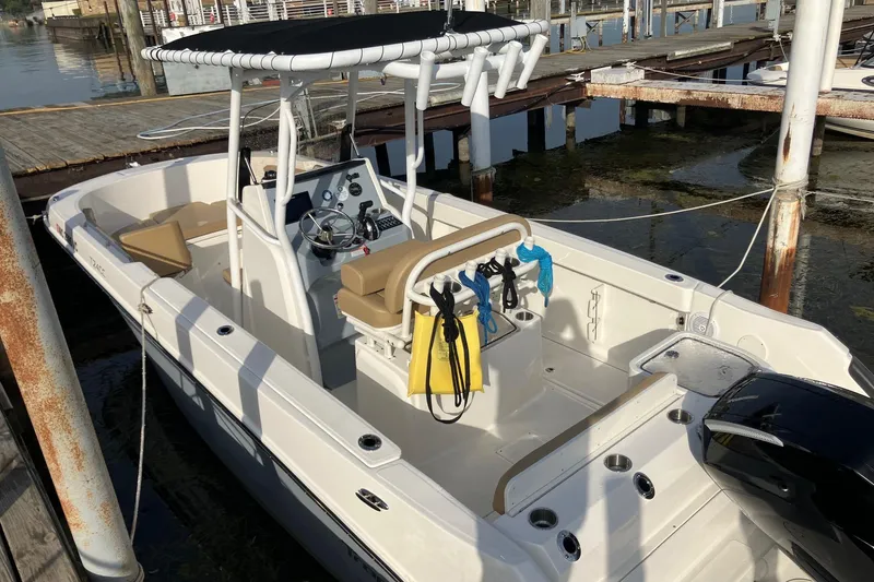 Slide: The Image of 2025 Bayliner Trophy T24CC boat docked, featuring spacious deck and modern console. - 3