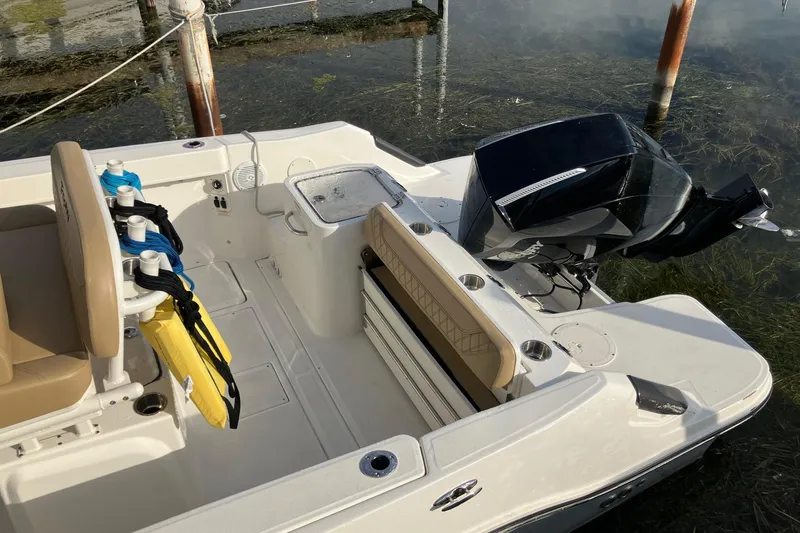 Slide: The Image of 2025 Bayliner Trophy T24CC boat interior with motor, seating, and storage features. - 4