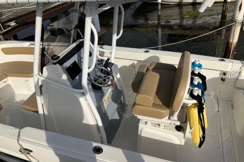 Slide: The Image of 2025 Bayliner Trophy T24CC boat interior with helm, seating, and storage features. - 5