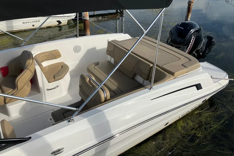 Slide: The Image of 2024 Bayliner VR6 Bowrider OB with tan seating and Mercury outboard engine. - 4