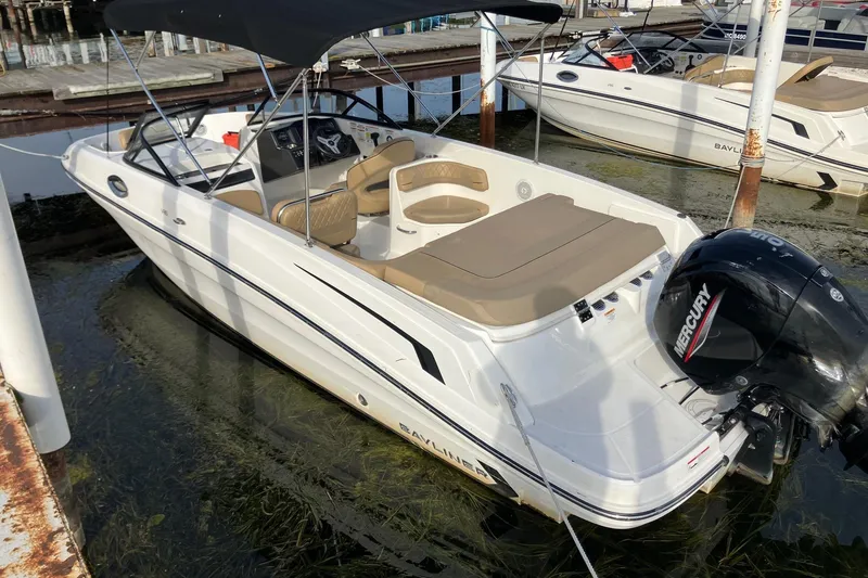Slide: The Image of 2024 Bayliner VR6 Bowrider OB with Mercury outboard engine docked at marina. - 5