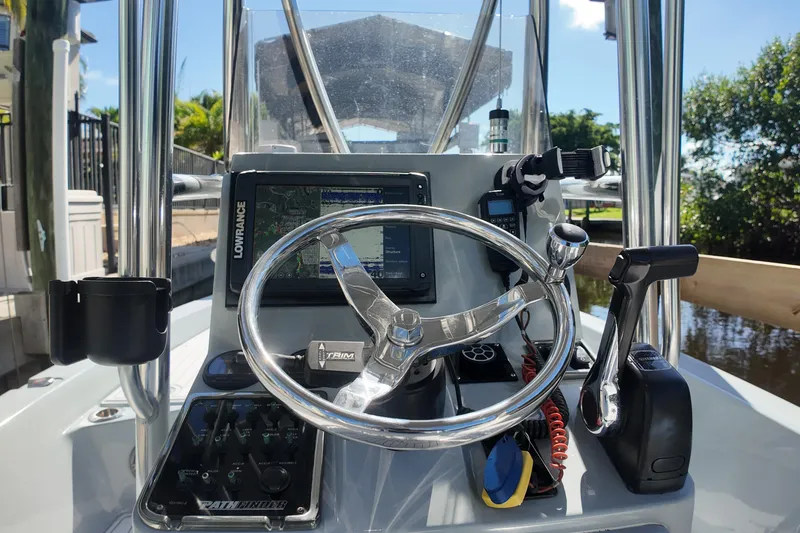 Slide: The Image of 2014 Pathfinder 2200 TRS boat console with steering wheel and navigation system. - 10
