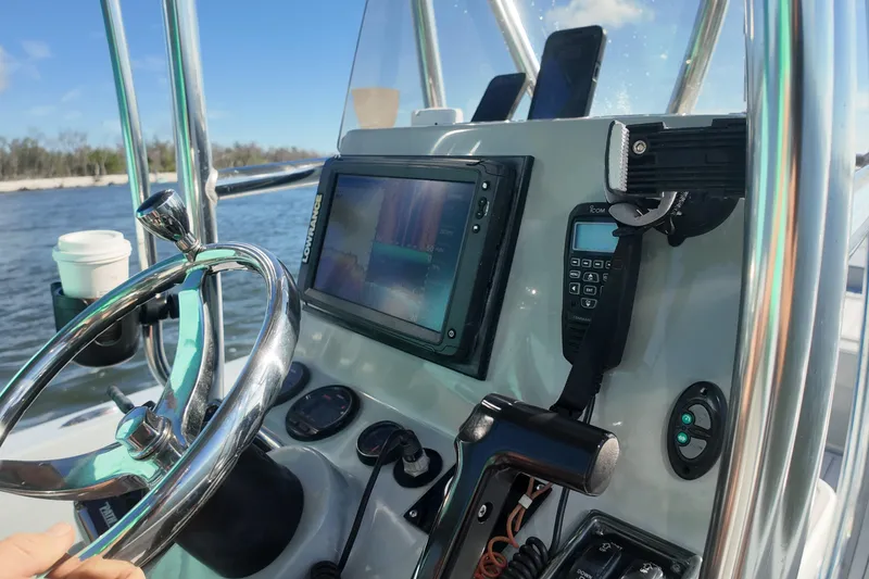Slide: The Image of 2014 Pathfinder 2200 TRS boat dashboard with steering wheel, navigation system, and communication devices. - 11