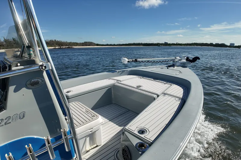 Slide: The Image of 2014 Pathfinder 2200 TRS boat cruising on a sunny day in open water. - 12