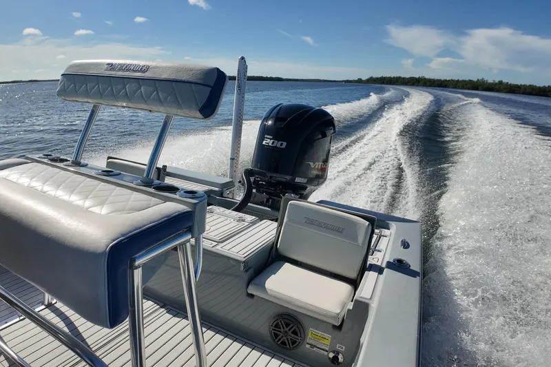 Slide: The Image of 2014 Pathfinder 2200 TRS boat cruising on open water, showcasing powerful engine and sleek design. - 14