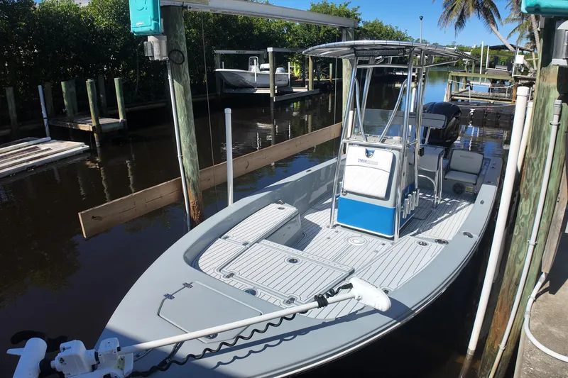 Slide: The Image of 2014 Pathfinder 2200 TRS boat docked in a sunny marina setting. - 15