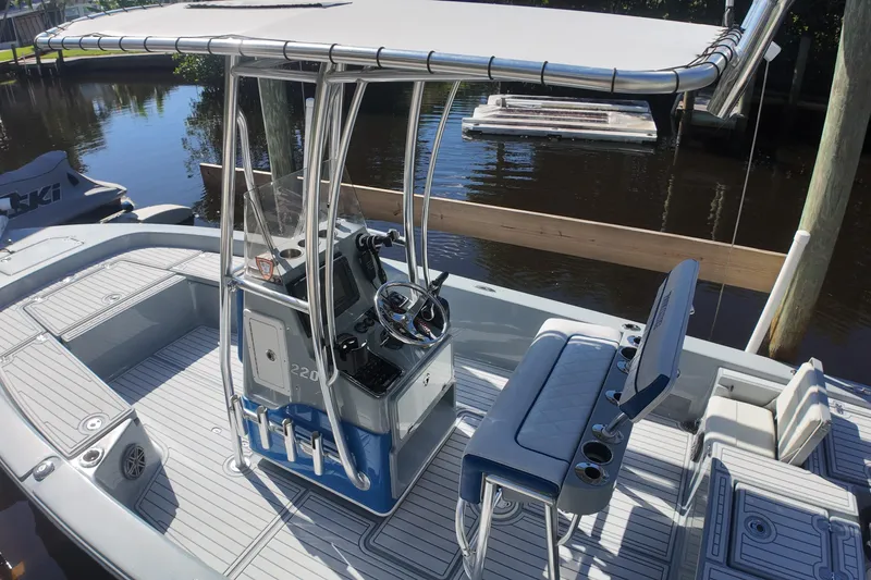 Slide: The Image of 2014 Pathfinder 2200 TRS boat with T-top and sleek interior design. - 16