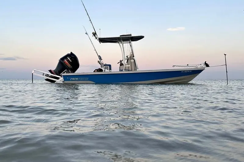 Slide: The Image of 2014 Pathfinder 2200 V Tournament Edition boat on calm water at sunset. - 18