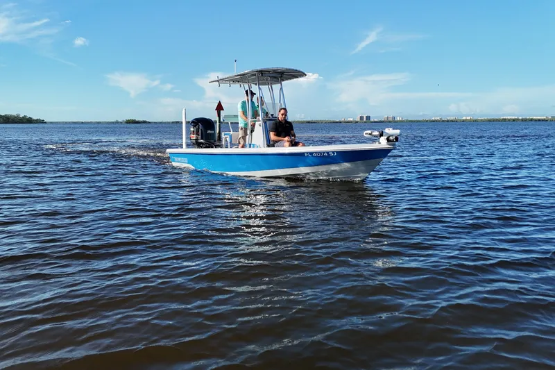 Slide: The Image of 2014 Pathfinder 2200 TRS boat cruising on a sunny day in open water. - 2