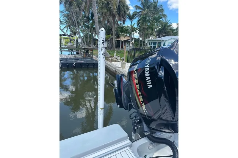 Slide: The Image of 2014 Pathfinder 2200 V Tournament Edition with Yamaha motor docked by palm trees. - 22