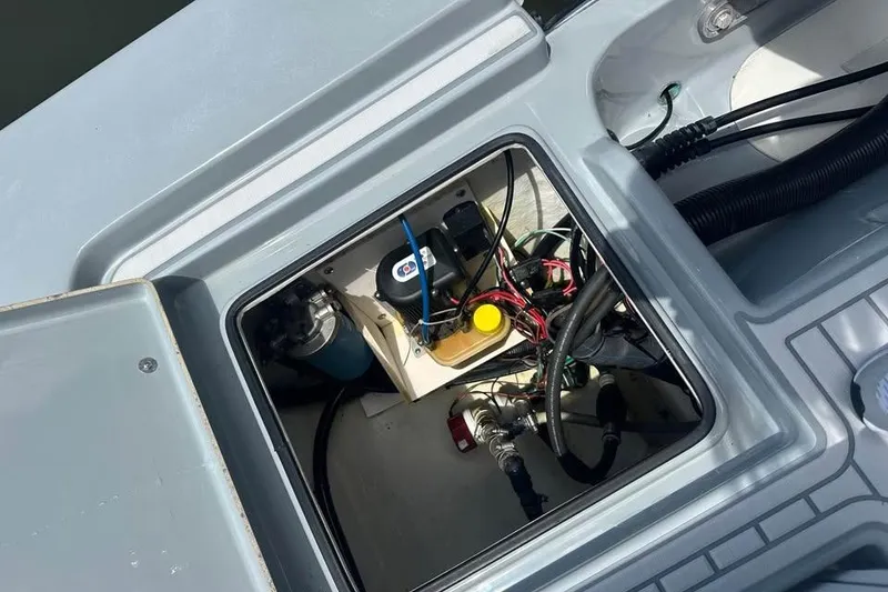 Slide: The Image of Open hatch of 2014 Pathfinder 2200 V Tournament Edition boat showing internal wiring and components. - 23