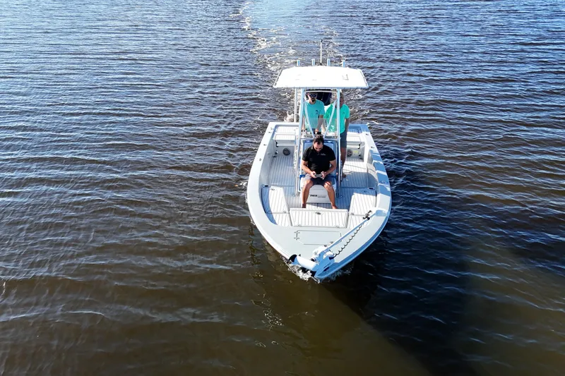 Slide: The Image of 2014 Pathfinder 2200 TRS boat cruising on open water with passengers onboard. - 3