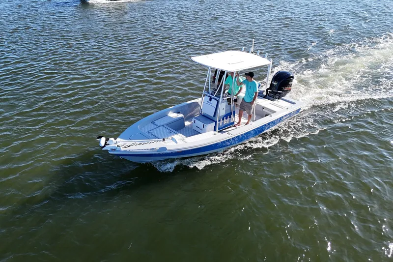 Slide: The Image of 2014 Pathfinder 2200 TRS boat cruising on open water with two passengers. - 5