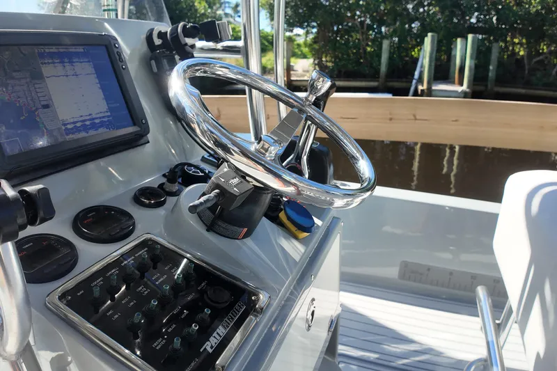 Slide: The Image of 2014 Pathfinder 2200 TRS boat dashboard with steering wheel and navigation controls. - 9