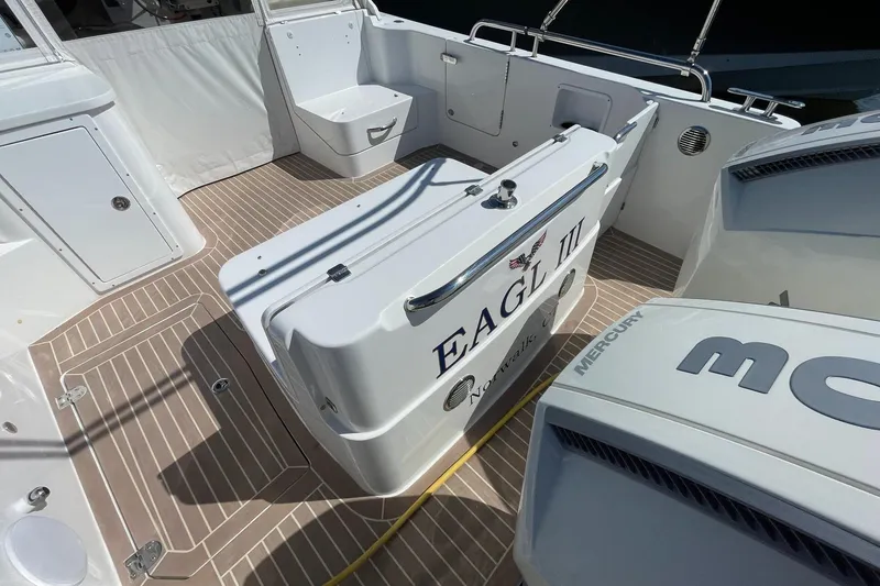 Slide: The Image of 2023 MJM 35 boat docked, featuring a sleek deck and modern design. - 13