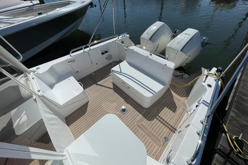 Slide: The Image of 2023 MJM 35 boat interior with open storage compartment and seating area. - 15