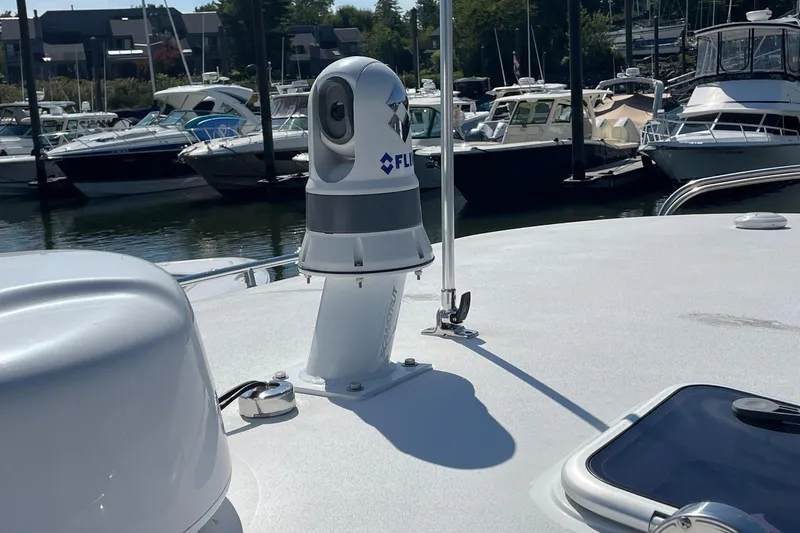 Slide: The Image of Twin outboard engines on a 2023 MJM 35 boat, docked in water. - 24