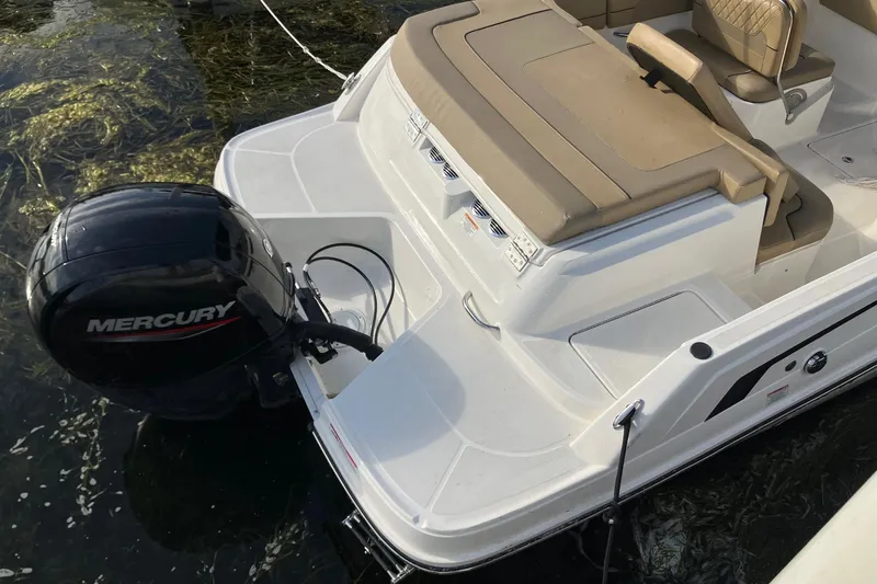 Slide: The Image of 2024 Bayliner VR6 Bowrider OB with Mercury outboard engine, docked on water. - 2