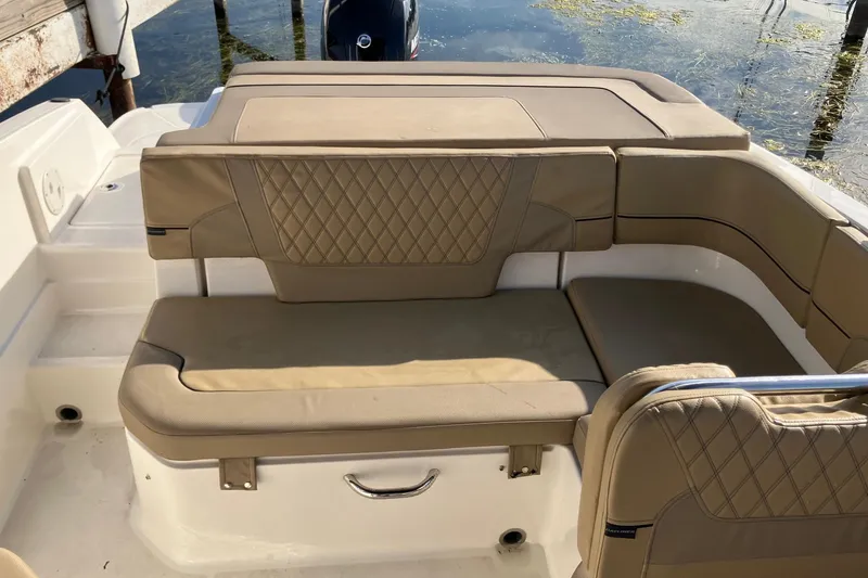 Slide: The Image of 2024 Bayliner VR6 Bowrider OB with tan cushioned seating and water view. - 5