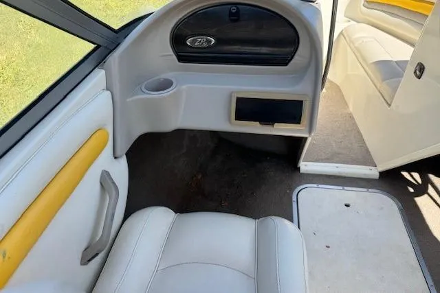 Slide: The Image of Interior of a 2003 Stingray 180LS boat with white and yellow seating. - 5