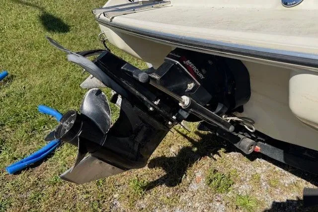 Slide: The Image of 2003 Stingray 180LS boat with Mercury outboard motor, parked on grass. - 8