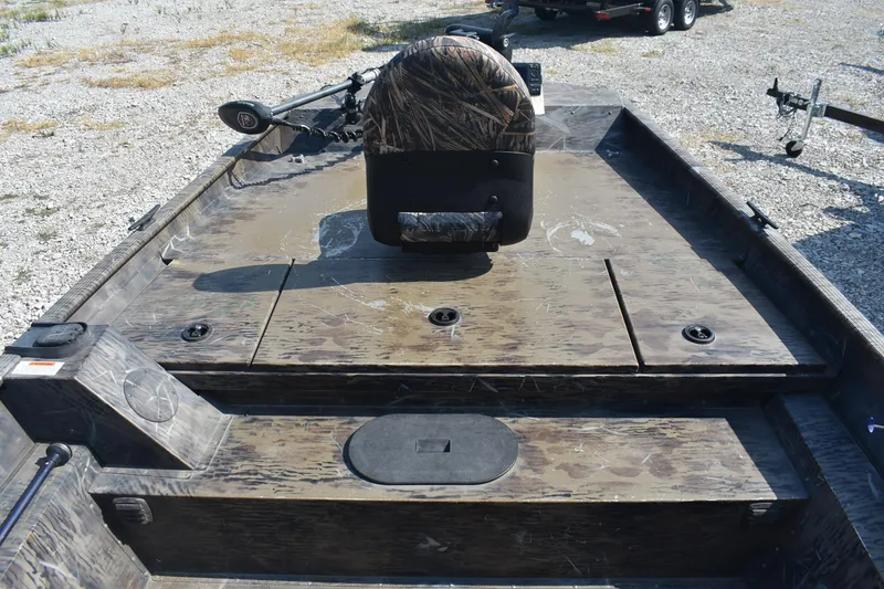 Slide: The Image of 2012 G3 1860 SC CAMO boat interior with camouflage seating and storage compartments. - 10