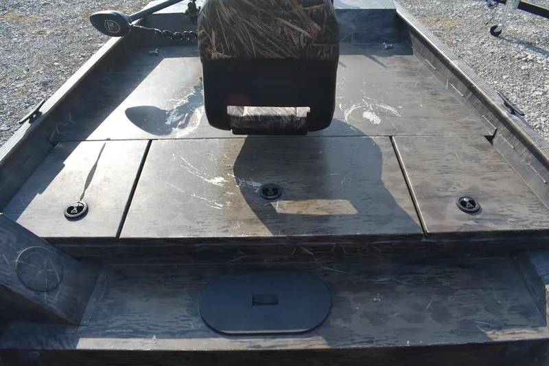 Slide: The Image of 2012 G3 1860 SC CAMO boat interior with camouflage seating and storage compartments. - 11