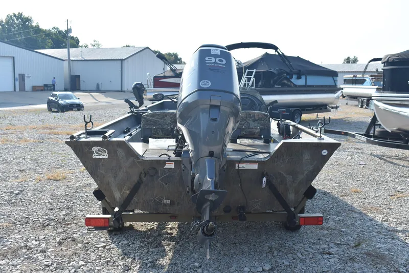 Slide: The Image of 2012 G3 1860 SC CAMO boat with 90 HP motor in a gravel lot. - 4