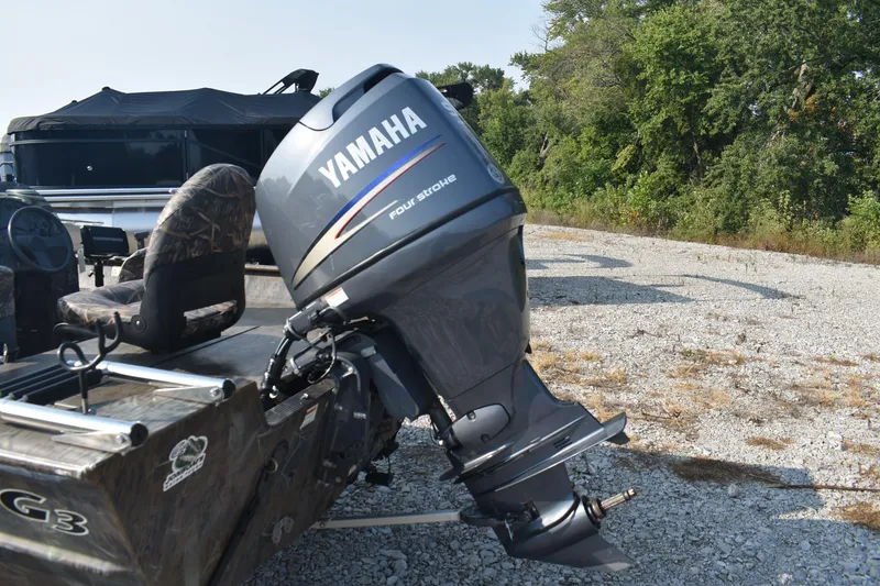 Slide: The Image of 2012 G3 1860 SC CAMO boat with Yamaha four-stroke outboard motor on gravel. - 5