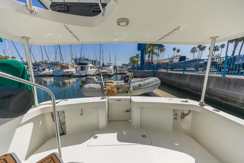 Slide: The Image of 2001 Mainship 390 Trawler docked at marina with surrounding boats and clear sky. - 10