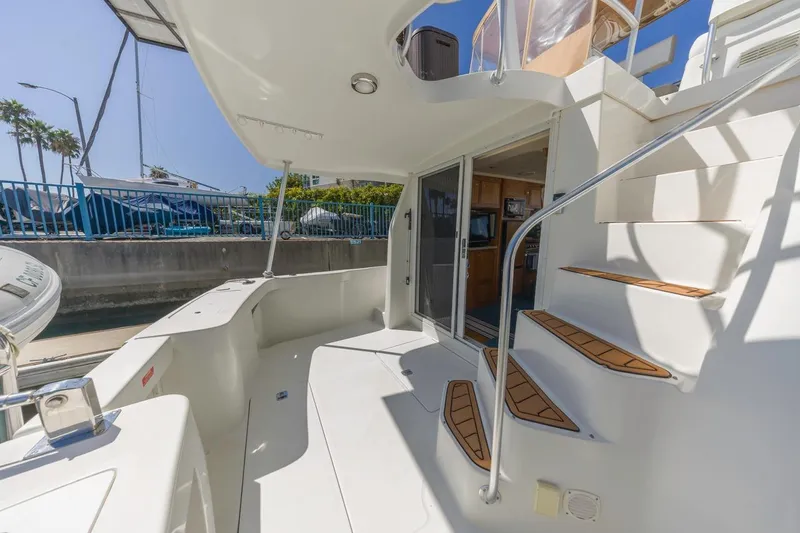 Slide: The Image of 2001 Mainship 390 Trawler boat deck with stairs and open cabin entrance. - 11