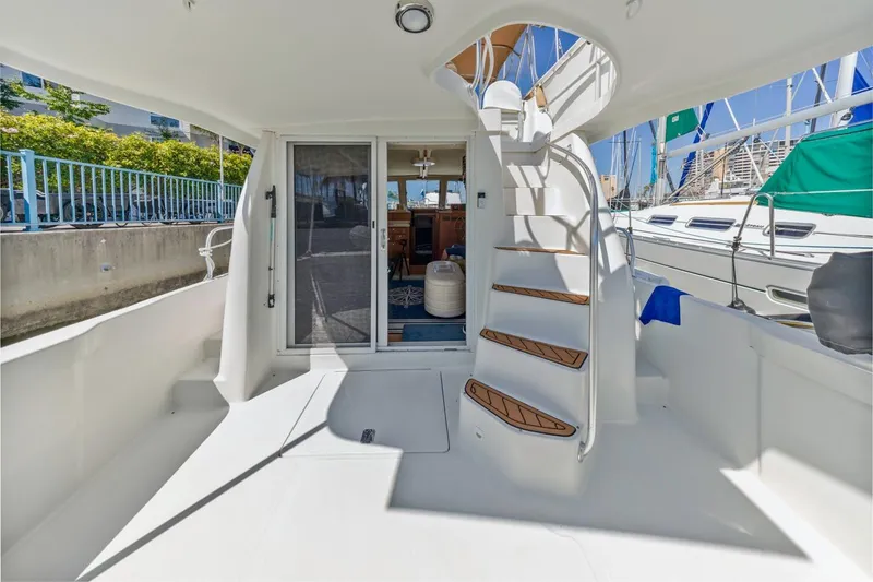 Slide: The Image of 2001 Mainship 390 Trawler boat deck with stairs and sliding door. - 13
