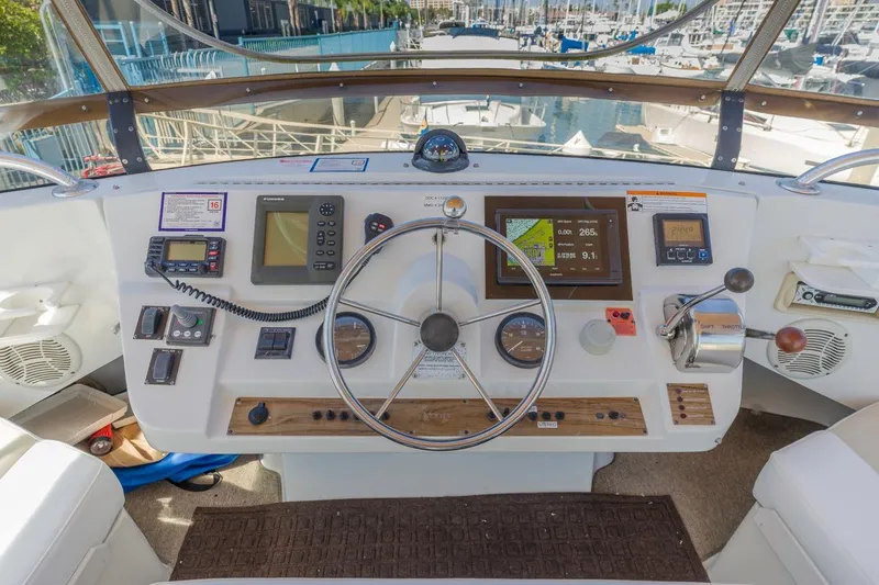 Slide: The Image of Helm of 2001 Mainship 390 Trawler with navigation instruments and steering wheel. - 17