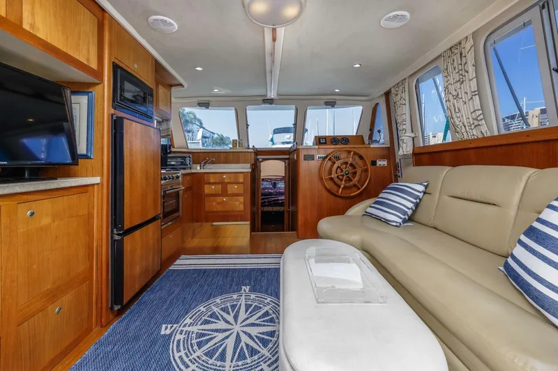 Slide: The Image of Interior of 2001 Mainship 390 Trawler with cozy seating and nautical decor. - 23