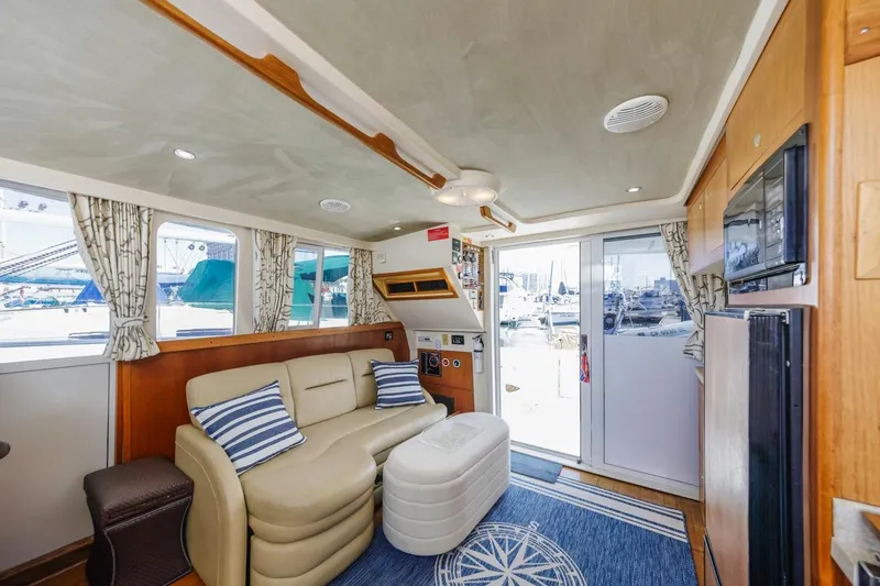 Slide: The Image of Interior of 2001 Mainship 390 Trawler with cozy seating and nautical decor. - 29