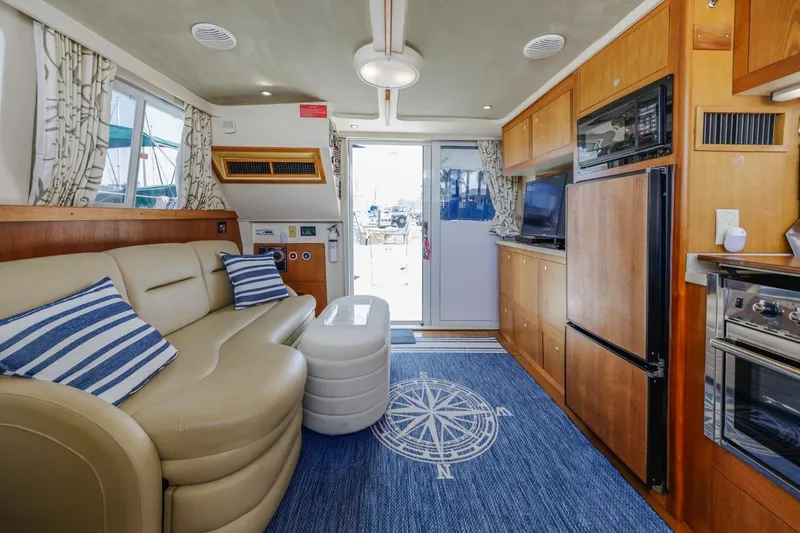 Slide: The Image of Interior of 2001 Mainship 390 Trawler with cozy seating and nautical decor. - 30