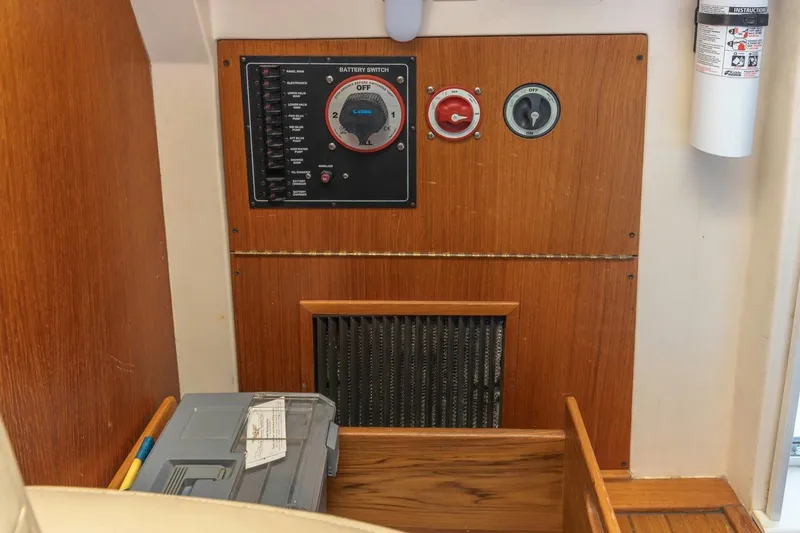 Slide: The Image of Control panel of a 2001 Mainship 390 Trawler with battery switch and fire extinguisher. - 32