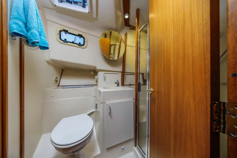 Slide: The Image of Bathroom interior of 2001 Mainship 390 Trawler with toilet, sink, and shower. - 36