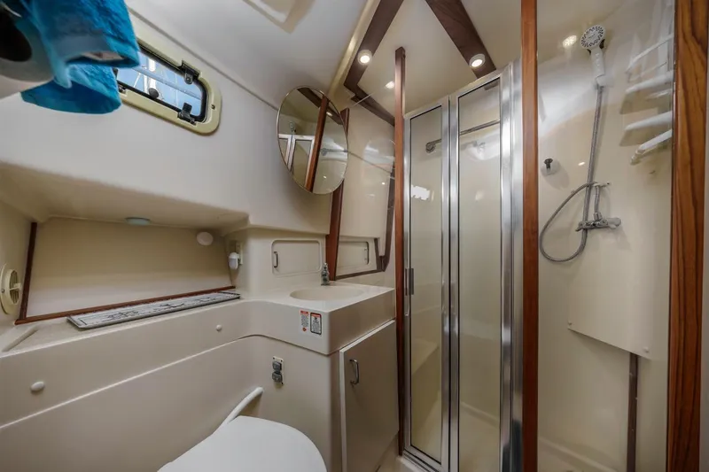 Slide: The Image of Bathroom of 2001 Mainship 390 Trawler with shower, sink, and mirror. - 37