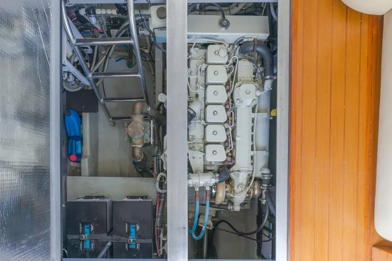 Slide: The Image of Engine room of 2001 Mainship 390 Trawler, showcasing engine and components. - 38