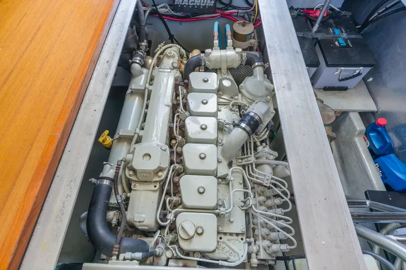 Slide: The Image of Engine compartment of a 2001 Mainship 390 Trawler, showcasing detailed mechanical components. - 39