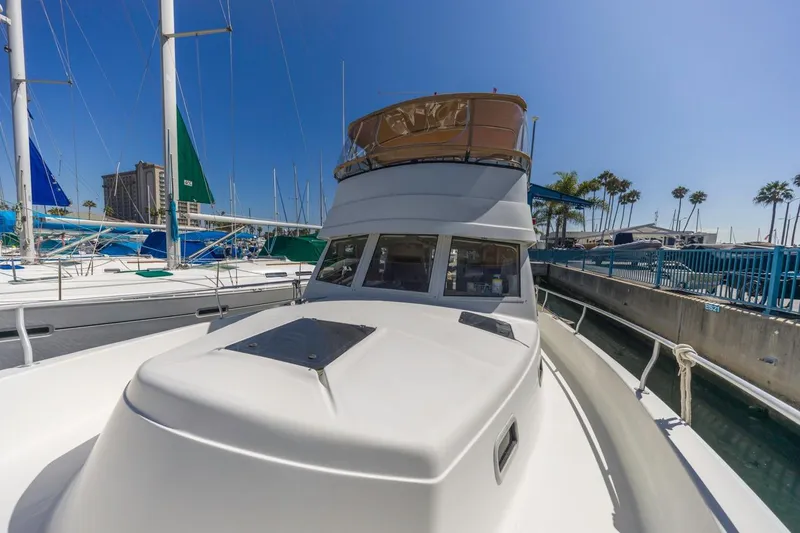 Slide: The Image of 2001 Mainship 390 Trawler docked at marina under clear blue sky. - 9