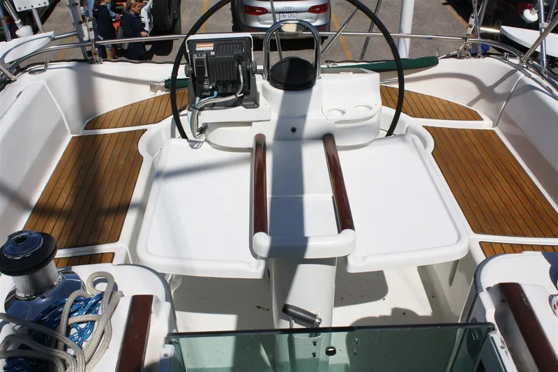 Slide: The Image of Cockpit of 1999 Beneteau Oceanis 352 sailboat with teak flooring and steering wheel. - 10