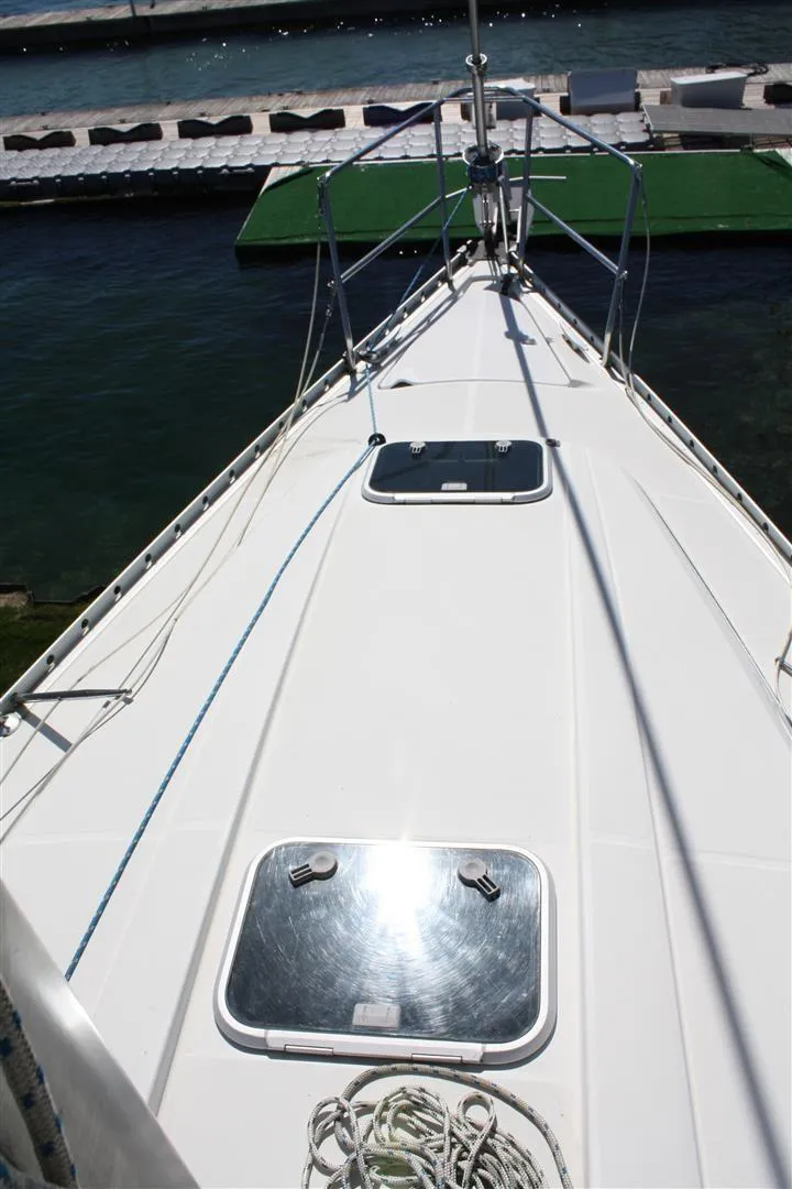 Slide: The Image of 1999 Beneteau Oceanis 352 sailboat deck with hatches, docked at marina. - 11