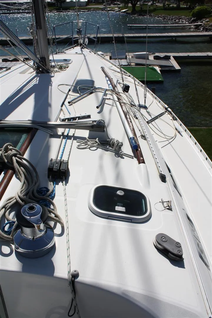 Slide: The Image of 1999 Beneteau Oceanis 352 sailboat deck with ropes and winches, docked at marina. - 13