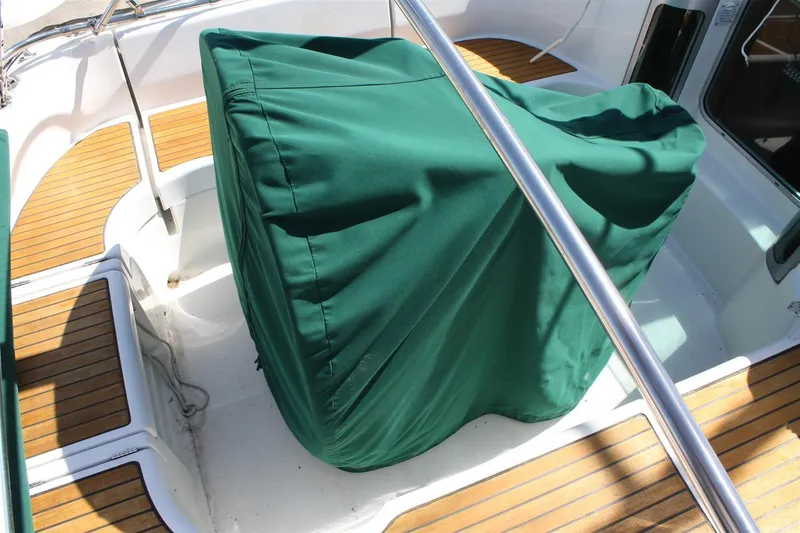 Slide: The Image of Covered cockpit area of a 1999 Beneteau Oceanis 352 sailboat with teak flooring. - 15